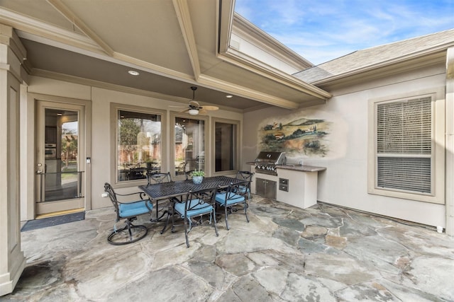 view of patio / terrace featuring grilling area, ceiling fan, and exterior kitchen