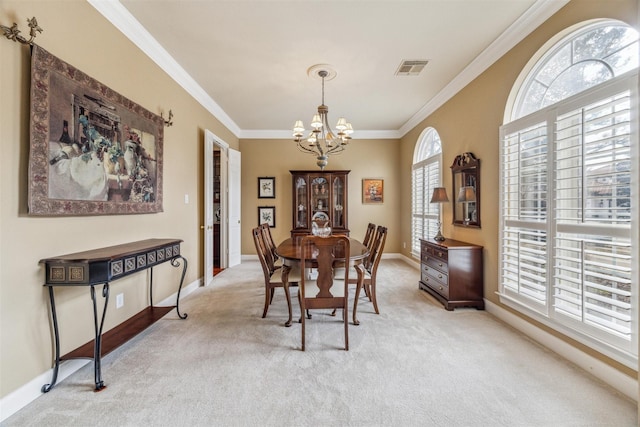 dining space featuring ornamental molding, light carpet, and a notable chandelier