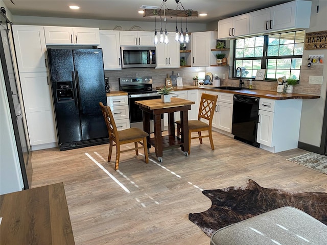TRACT2 Private Road 648th St, Cedar Lake, TX 77414 - kitchen with open shelves, a sink, butcher block counters, light wood-style flooring, and black appliances