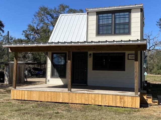 back of property featuring metal roof