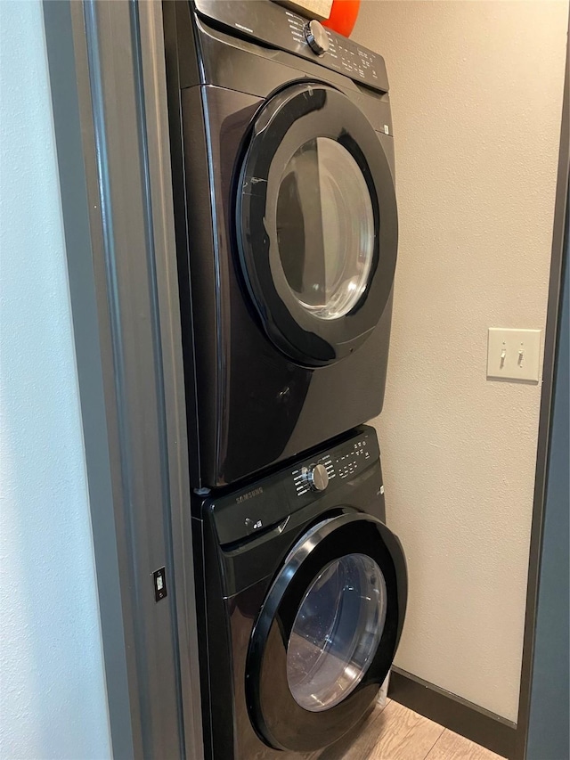 TRACT2 Private Road 648th St, Cedar Lake, TX 77414 - clothes washing area featuring baseboards, wood finished floors, stacked washing maching and dryer, and laundry area