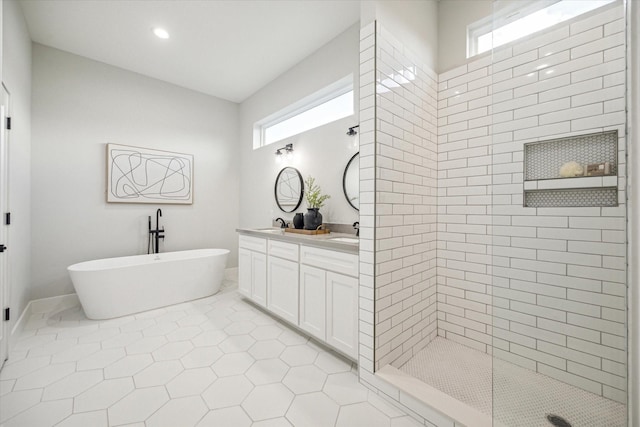 bathroom featuring plus walk in shower, tile patterned floors, and vanity