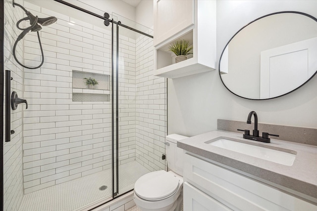 bathroom with vanity, toilet, and a shower with door