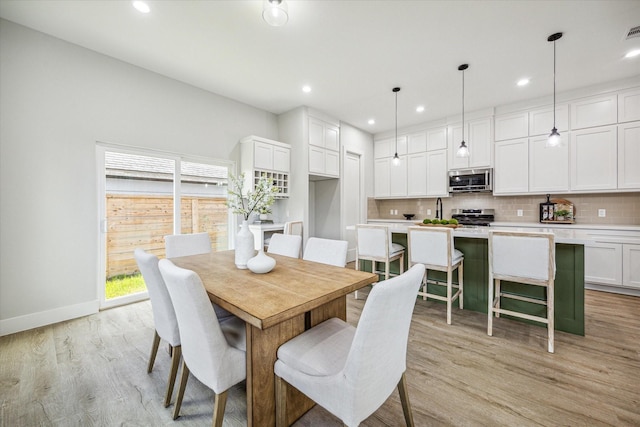 dining space featuring light wood-type flooring