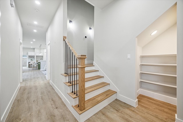 staircase with hardwood / wood-style floors