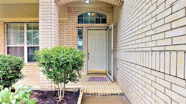 property entrance featuring brick siding