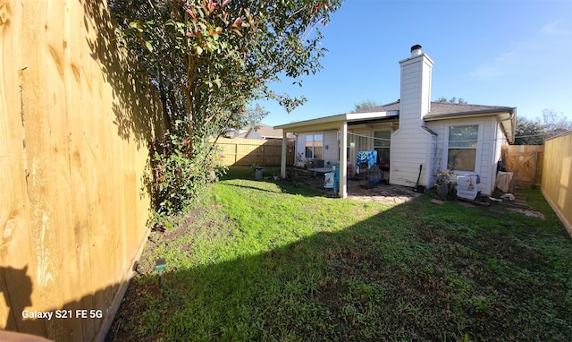 rear view of property featuring a lawn