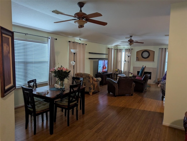 dining area with dark hardwood / wood-style floors and ceiling fan