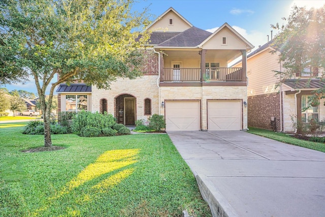 view of front of property with a garage, a front yard, and a balcony