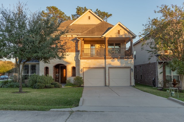 view of front of property featuring a balcony, a garage, and a front yard