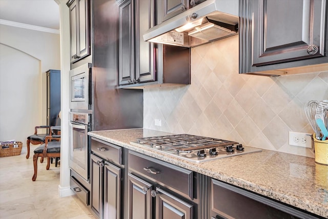 kitchen featuring ornamental molding, appliances with stainless steel finishes, and dark brown cabinetry