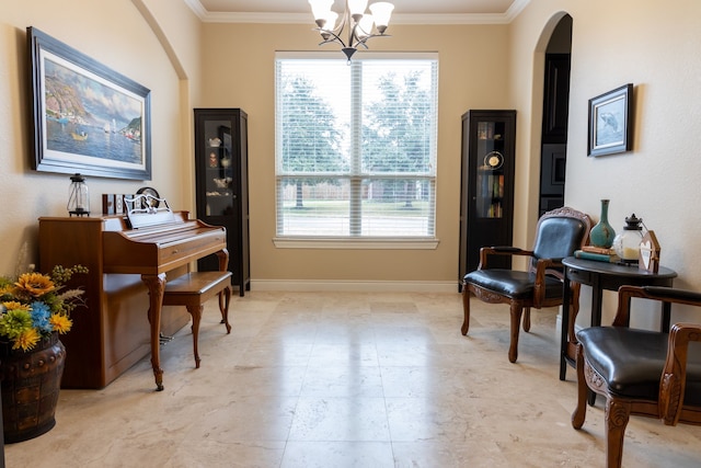 sitting room with ornamental molding and a chandelier