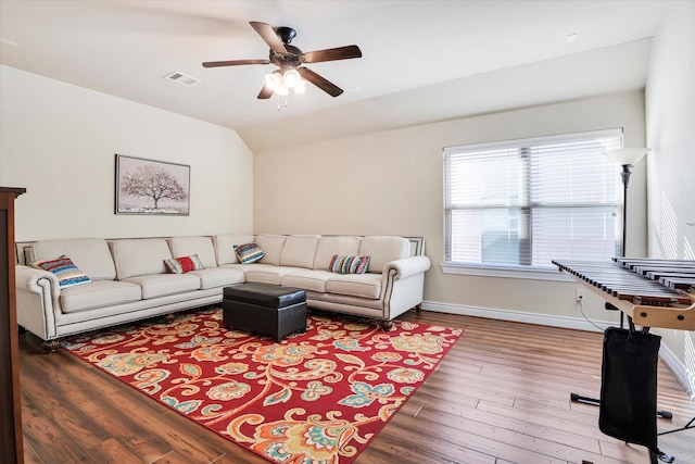 living room with vaulted ceiling, hardwood / wood-style floors, and ceiling fan