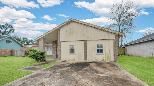 rear view of property featuring a lawn