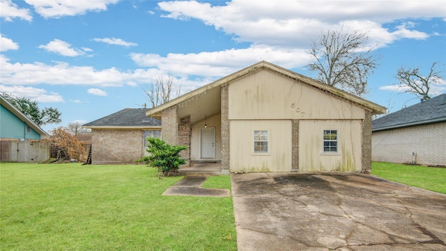 rear view of house featuring a lawn