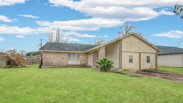 rear view of property with a lawn