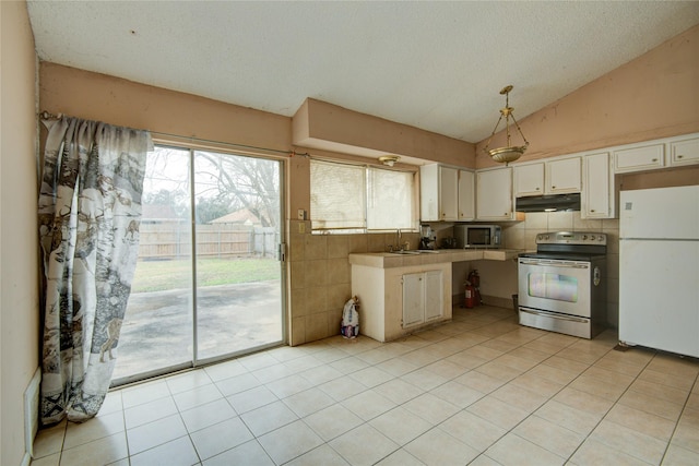 kitchen featuring sink, vaulted ceiling, white cabinetry, white refrigerator, and stainless steel electric stove