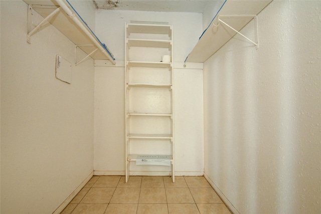 walk in closet with tile patterned flooring