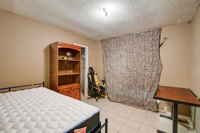 tiled bedroom with a textured ceiling