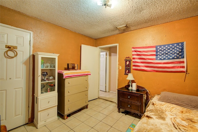 tiled bedroom featuring a textured ceiling