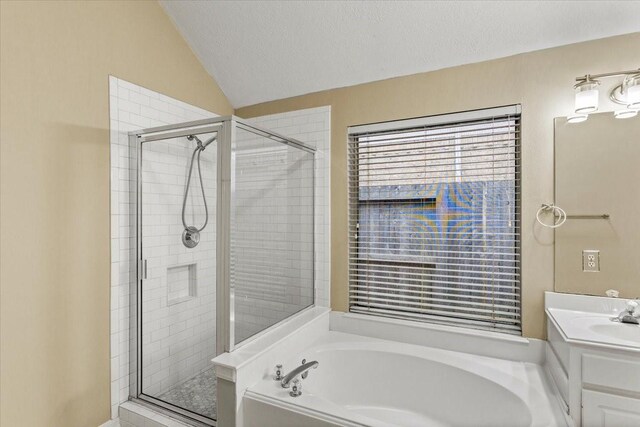 full bath with a textured ceiling, a shower stall, vanity, and a bath