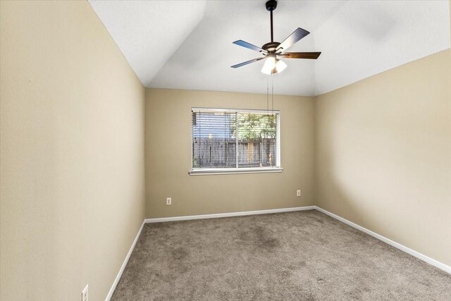 unfurnished room with lofted ceiling, baseboards, carpet floors, and a ceiling fan