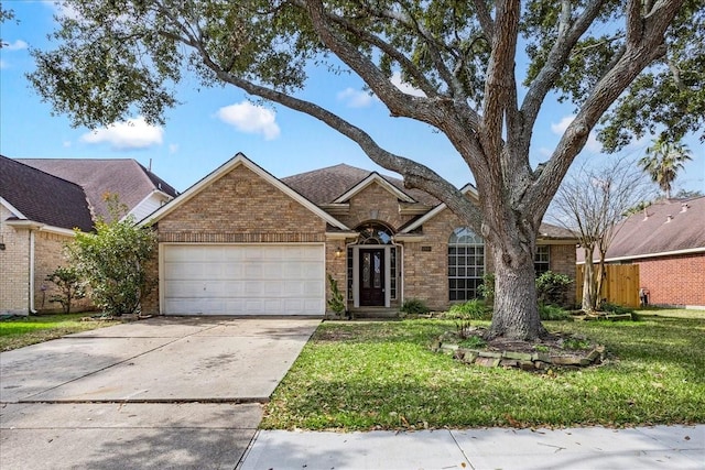 view of front facade with a garage and a front lawn