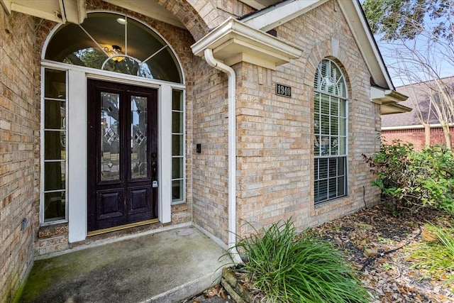 property entrance featuring brick siding