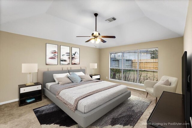 bedroom featuring light carpet, baseboards, visible vents, a ceiling fan, and vaulted ceiling