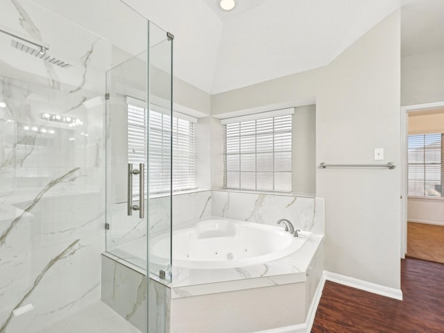 bathroom featuring lofted ceiling, wood-type flooring, shower with separate bathtub, and a wealth of natural light