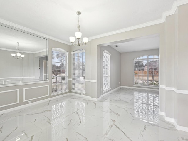 unfurnished dining area featuring ornamental molding and a chandelier