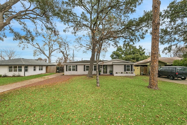 ranch-style home with a front yard and a carport