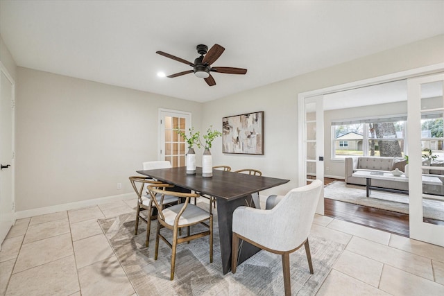 tiled dining room featuring ceiling fan