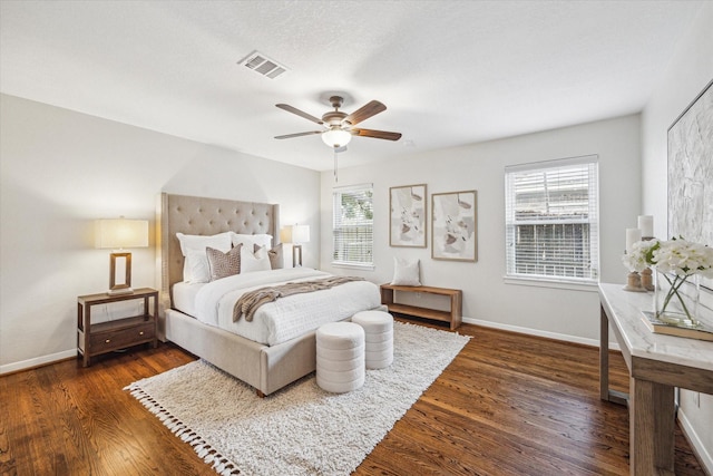 bedroom with ceiling fan and dark hardwood / wood-style flooring