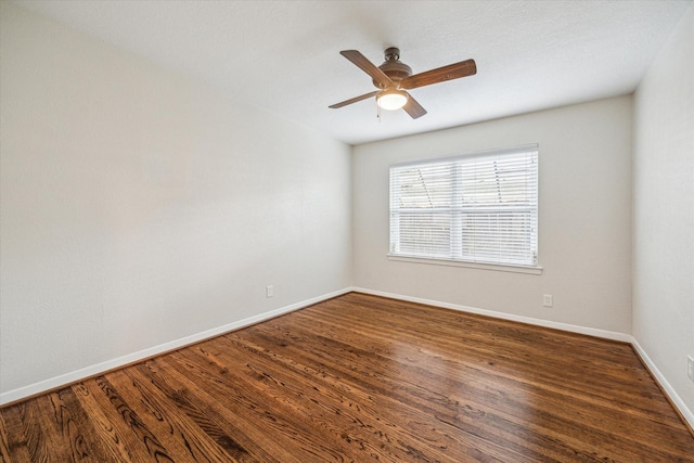 spare room with ceiling fan and dark hardwood / wood-style flooring