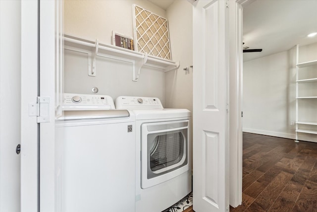 laundry area with dark hardwood / wood-style floors and washer and clothes dryer