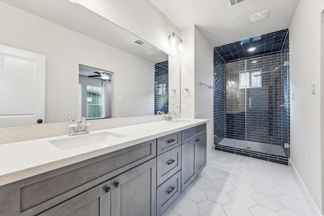 bathroom with ceiling fan, vanity, an enclosed shower, and tile patterned flooring