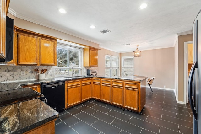 kitchen featuring pendant lighting, sink, dark stone countertops, black appliances, and kitchen peninsula