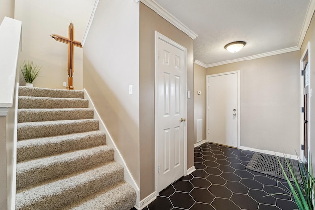 tiled foyer featuring crown molding