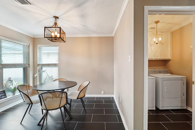 dining area with ornamental molding, washer and clothes dryer, and a chandelier