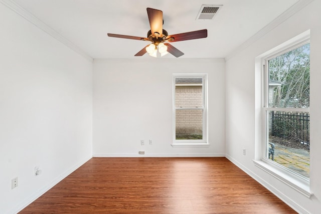 spare room with wood-type flooring, ceiling fan, and crown molding