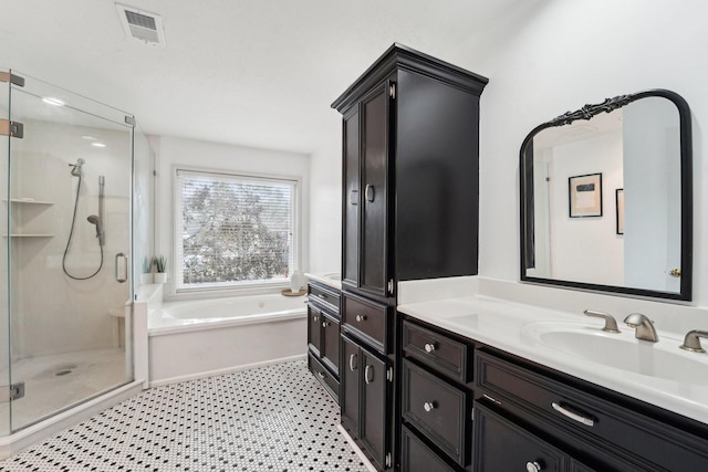 bathroom featuring vanity, tile patterned floors, and shower with separate bathtub