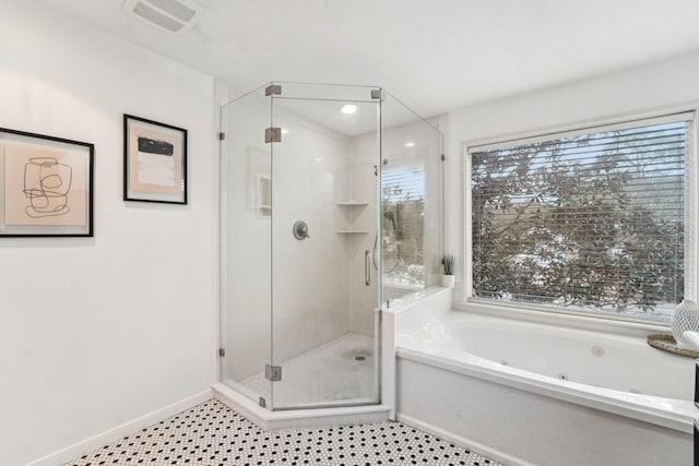 bathroom featuring shower with separate bathtub and a wealth of natural light