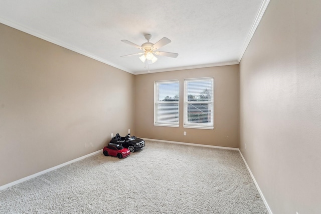 carpeted spare room with ornamental molding and ceiling fan