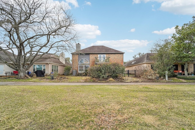 view of front of property featuring a front yard and central air condition unit