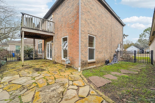 view of home's exterior with a balcony and a patio area