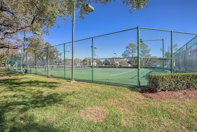 view of sport court with a lawn