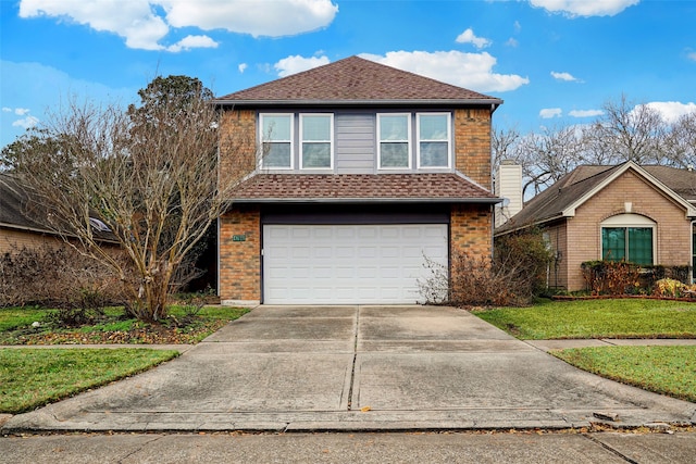 view of front of property with a garage and a front lawn