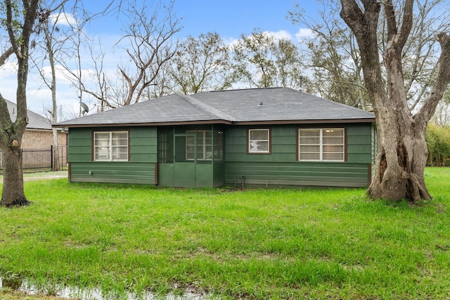 back of property featuring a lawn