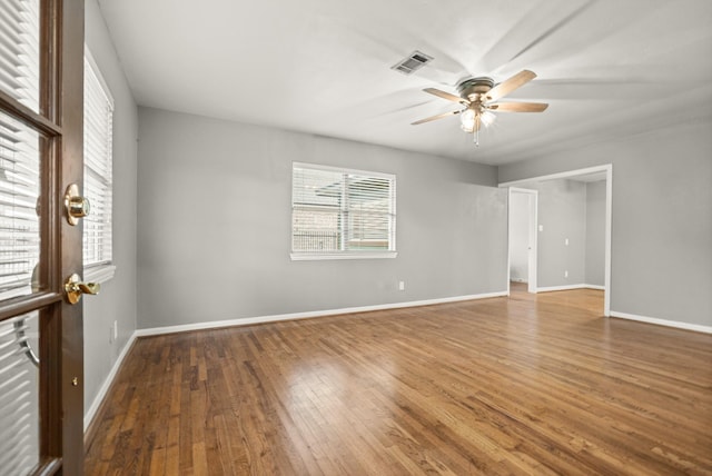 empty room featuring hardwood / wood-style flooring and ceiling fan